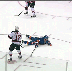 Three professional hockey players playing.