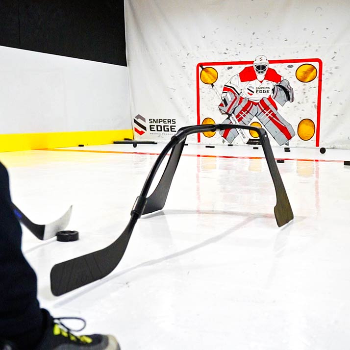 a player stickhandling through the attack triangle in front of a shooting tarp