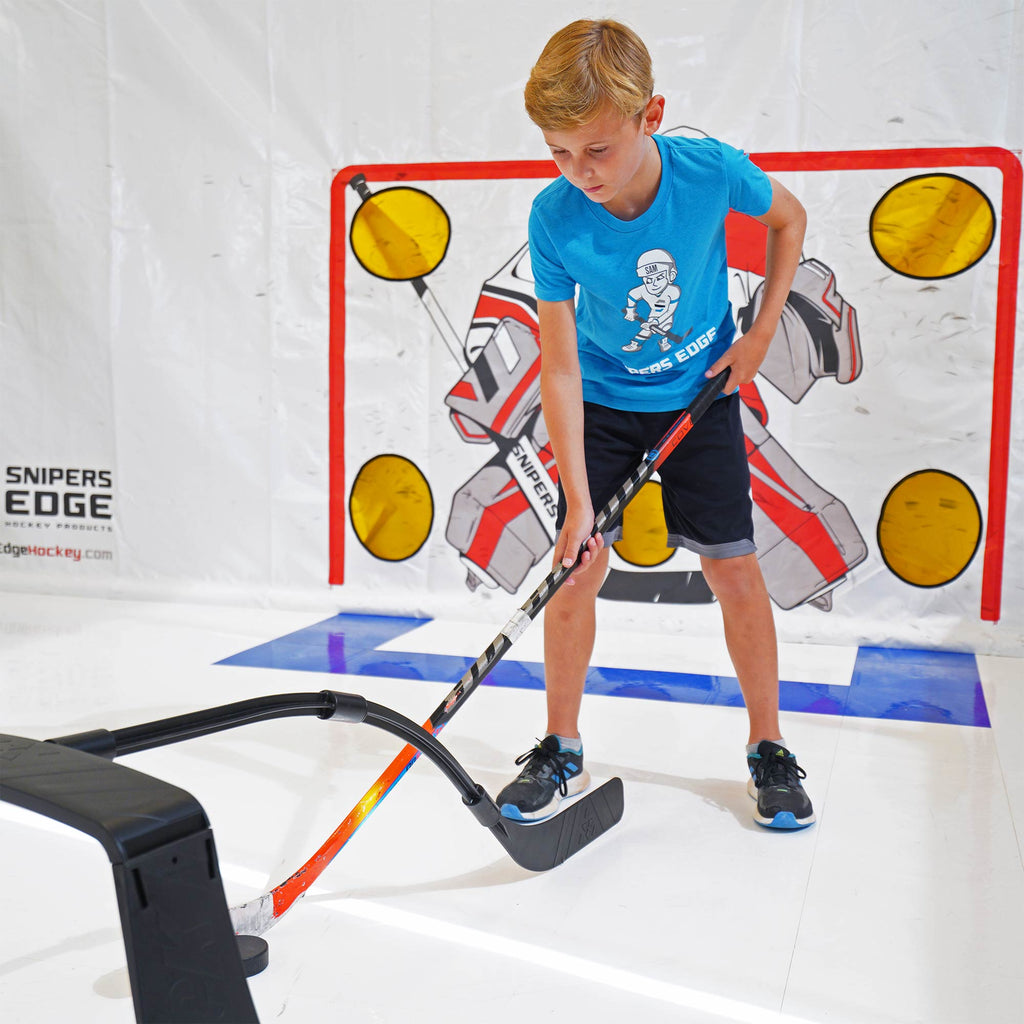 boy in blue shirt stick handling using the attack triangle in front of goal