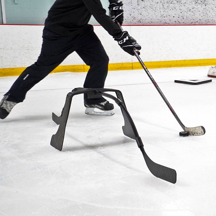 An Attack Triangle on ice with a player stickahndling through it