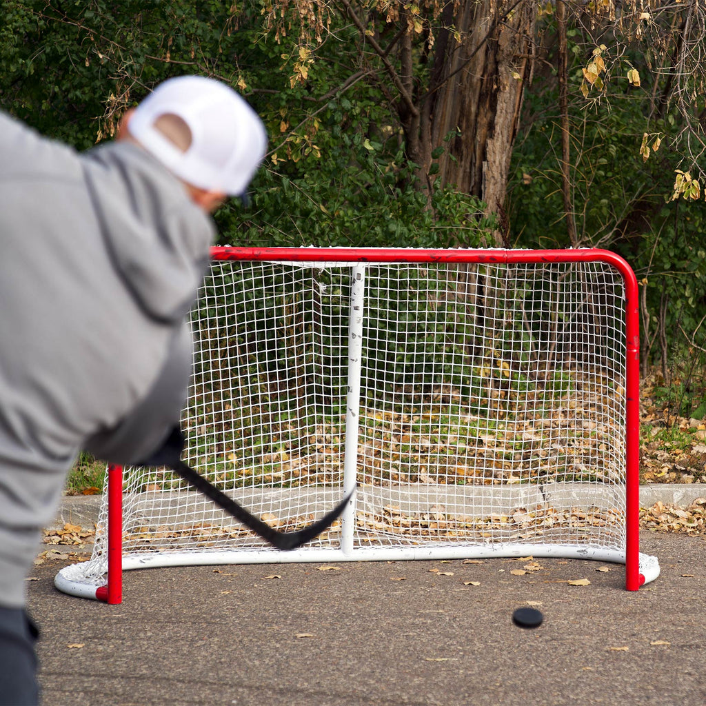 Player shooting on Backyard Hockey Goal Net