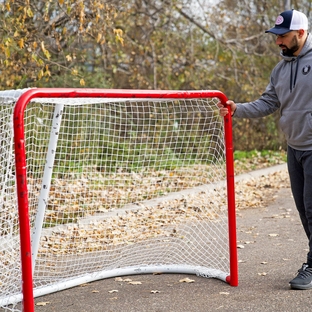 Man standing next to his Snipers Edge Backyard Goal