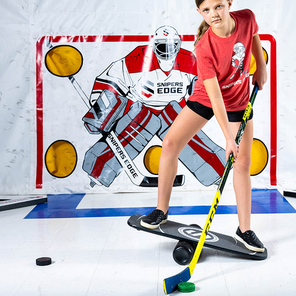 a player on the balance board holding a hockey stick