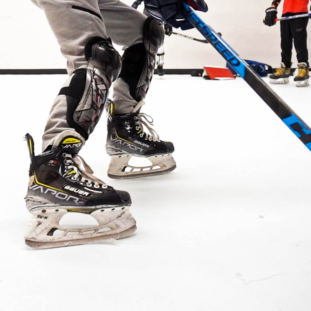 Close up of skates on synthetic ice